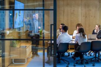 People in an office looking at a screen